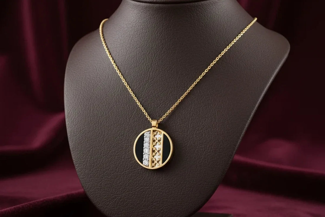 Gold pendant necklace with diamond and textured detail on a jewellery display