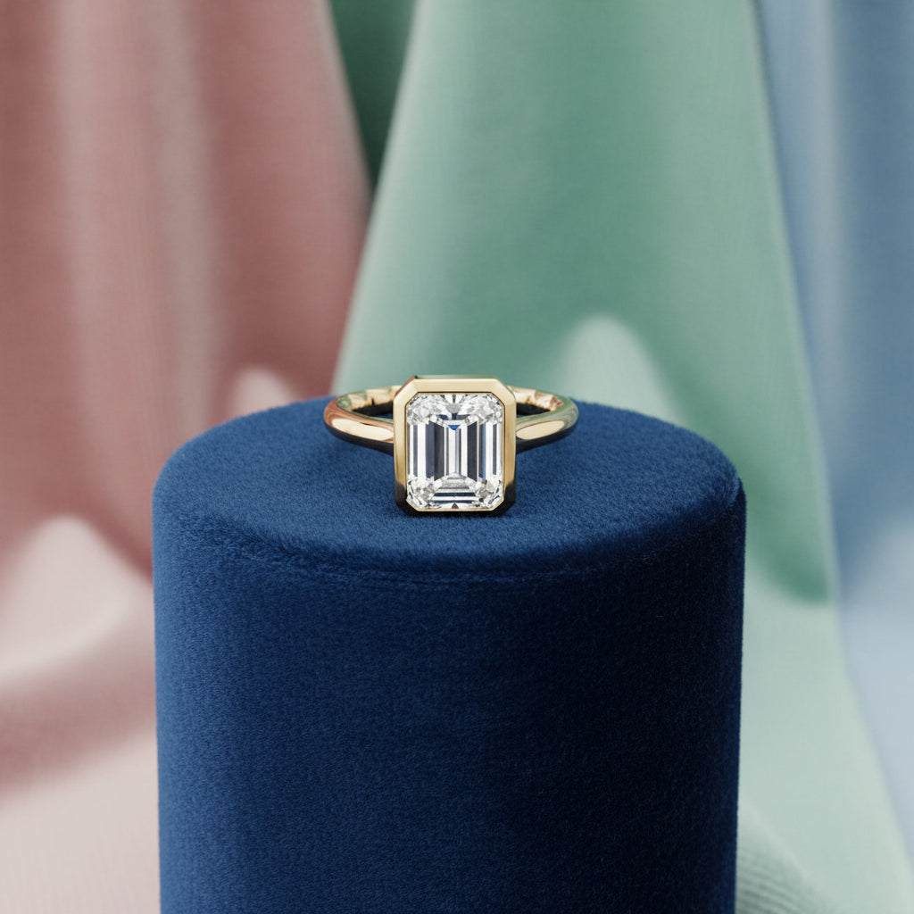 14K Yellow gold solitaire with a bezel set emerald cut lab diamond