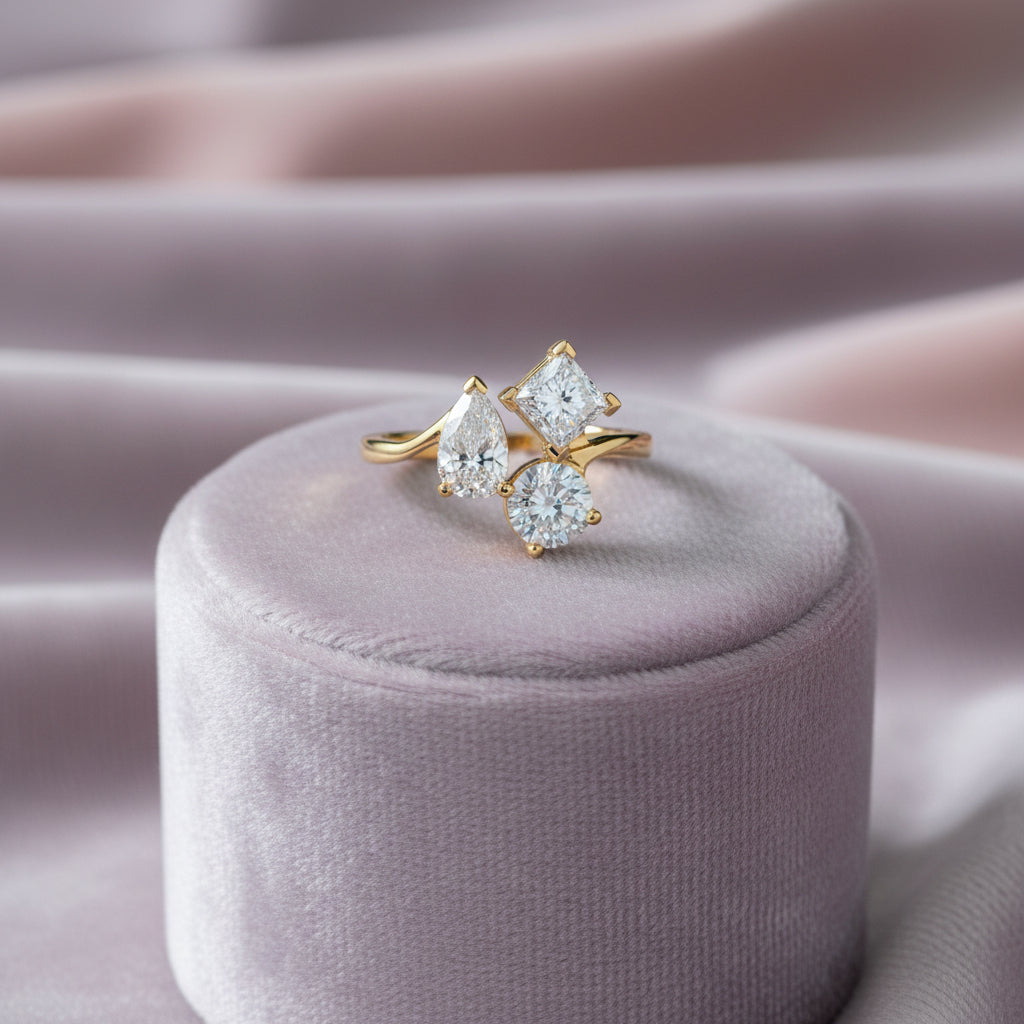 14K YG Lab Grown Diamond Ring containing 1=1.07ct Pear Shaped Lab, 1=1.09ct Round Lab & 1.01ct Pr...