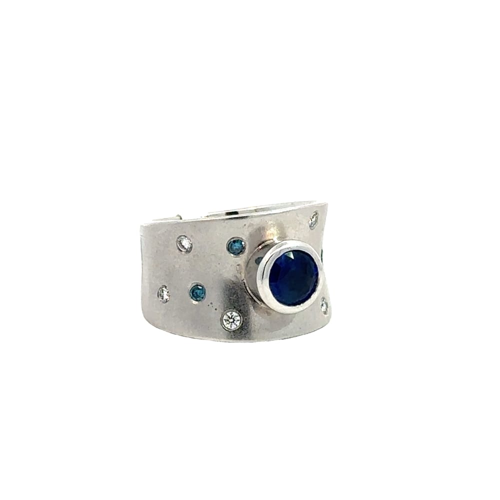 CUSTOM 14K WG CONCAVE WIDE BAND WITH ENHANCED BLUE DIAMOND AND WHITE DIAMOND GYPSY SET ON EITHER ...