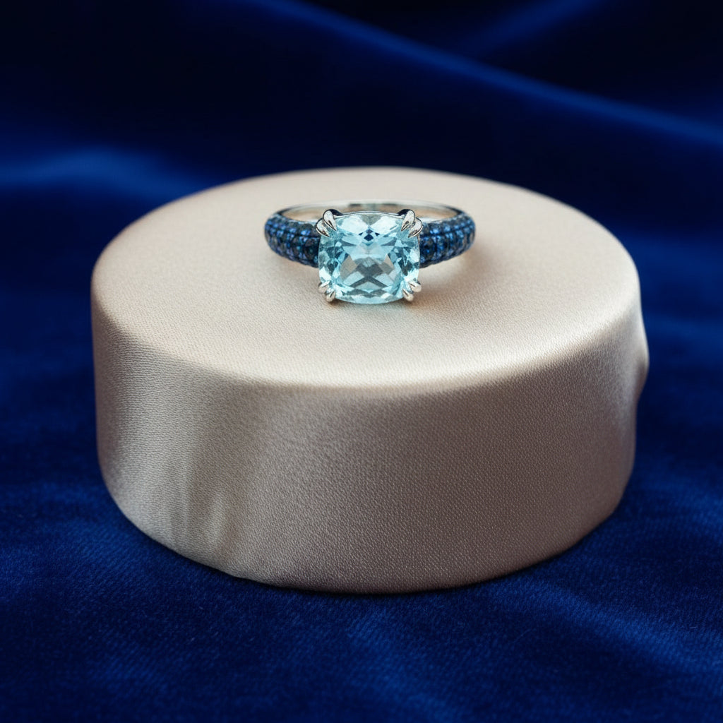 18K White gold ring with sky blue topaz center and blue sapphire sides
