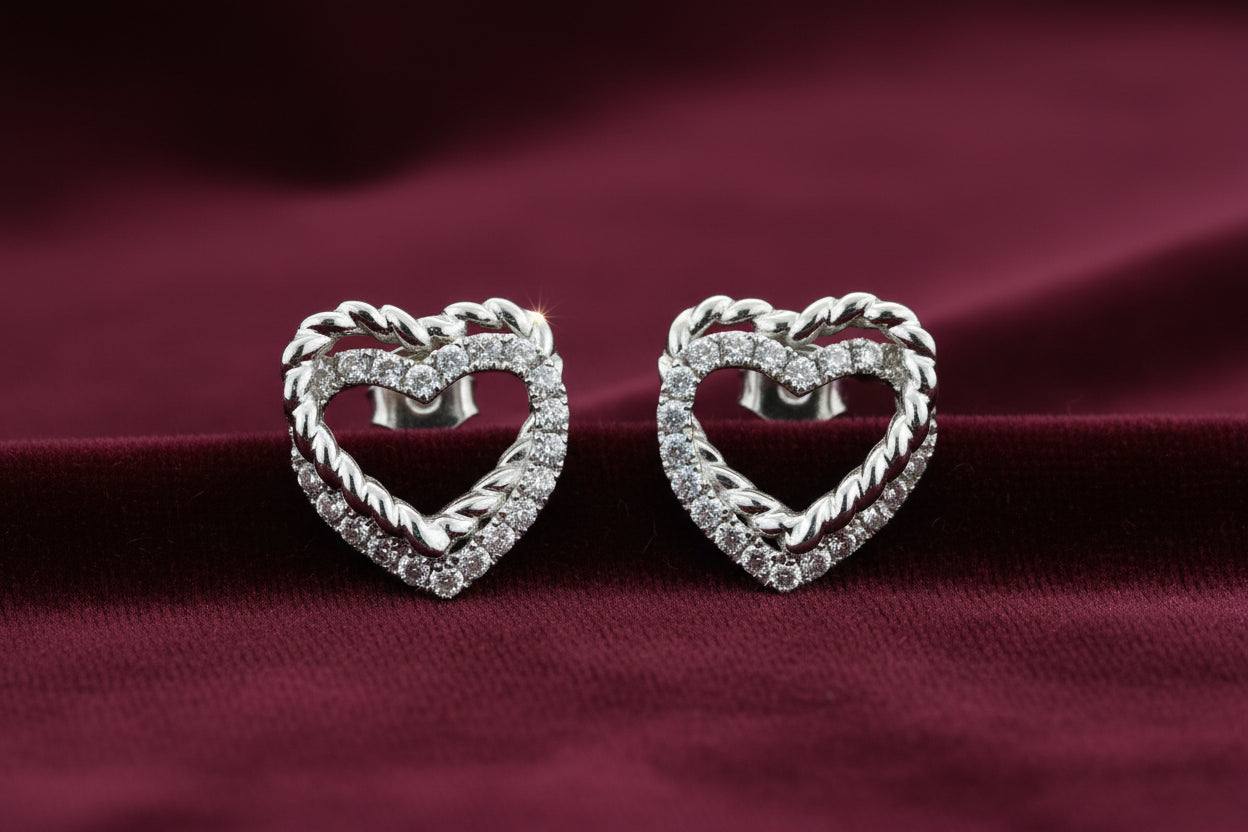 18K WHITE GOLD HEART EARRINGS SET WITH 0.30TW OF DIAMONDS.